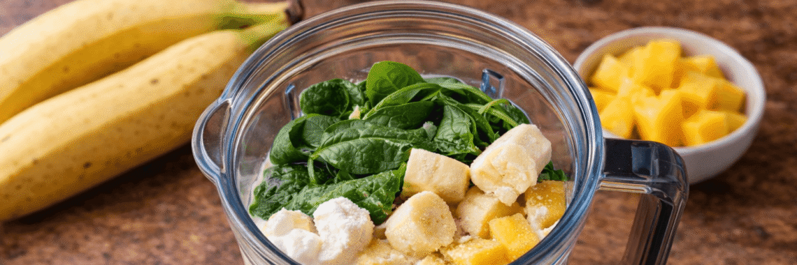 Green smoothie prep on wooden surface Green smoothie prep on wooden surface